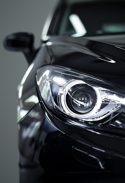 close up of a black car headlight showcasing modern design and advanced technology with five LED lights