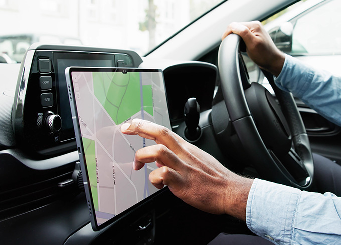 person using a touchscreen navigation system in a car showing a map interface for driving directions with focus on technology and navigation features