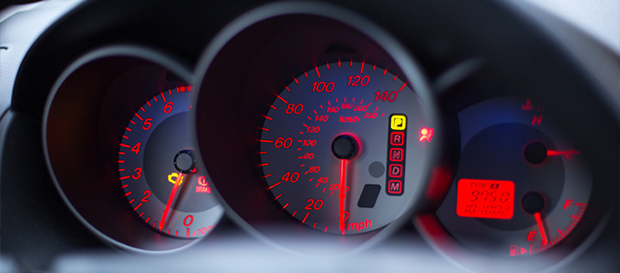 car dashboard with speedometer fuel gauge and warning lights showing important vehicle information including speed and engine status 4 features for safe driving